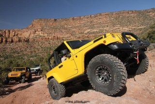 Mopar revealed the Jeep Wrangler Trail Boss image vehicle at the 44th annual Easter Jeep Safari in Moab, Utah.  The Jeep Wrangler Trail Boss was built to showcase Mopar off-road products in the brand’s trail catalog.  The Trail Boss is a two-door Jeep Wrangler Rubicon that is built for serious off-road duty.  The vehicle features a half-door kit, sun bonnet, front and rear AEV off-road bumpers, a Warn 9.5ti winch, rear-tire carrier, AEV hood, 3-inch lift kit, Hutchinson Rock Monster beadlock wheels, Katzkin leather seat trim kit, slush mats and a Kicker audio system.