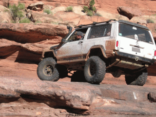 matt-checking-the-step-obstacle-on-the-moab-rim-trail