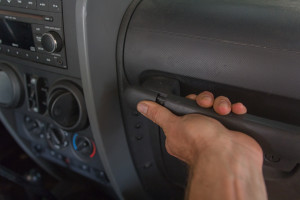 Slide the cover towards the center of the Jeep.