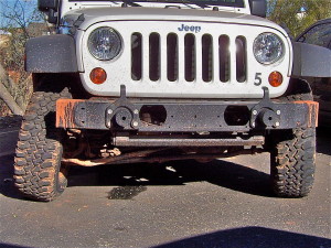 Front end of a Jeep with a broken axle housing.