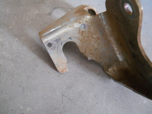 Two holes drilled in the Jeep JK transfer case bracket